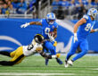 Detroit Lions running back Jahmyr Gibbs (0) runs the ball during the first quarter against the Pittsburgh Steelers at Ford Field.