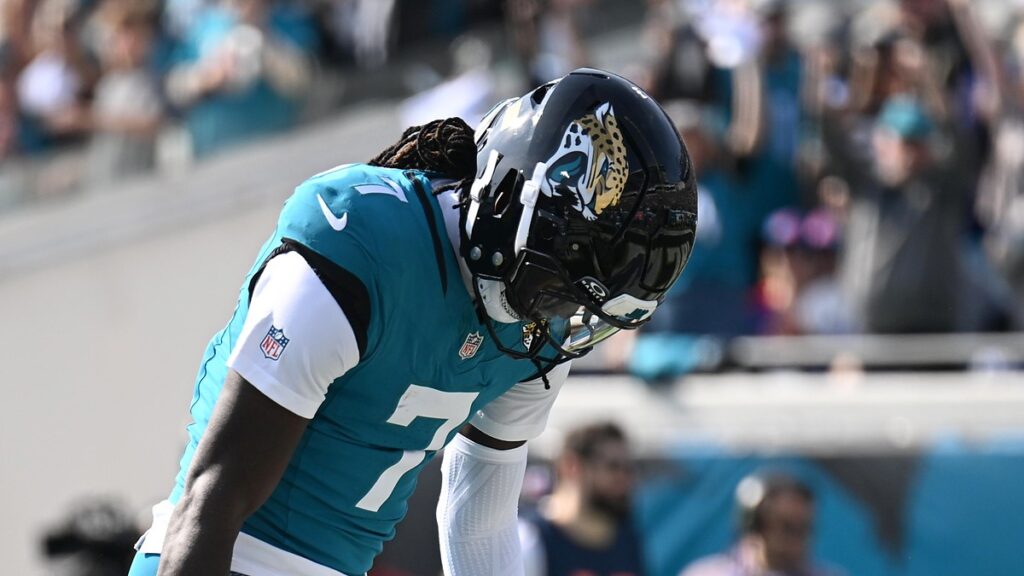 Jacksonville Jaguars wide receiver Brian Thomas Jr. bends over and looks down after scoring a touchdown.