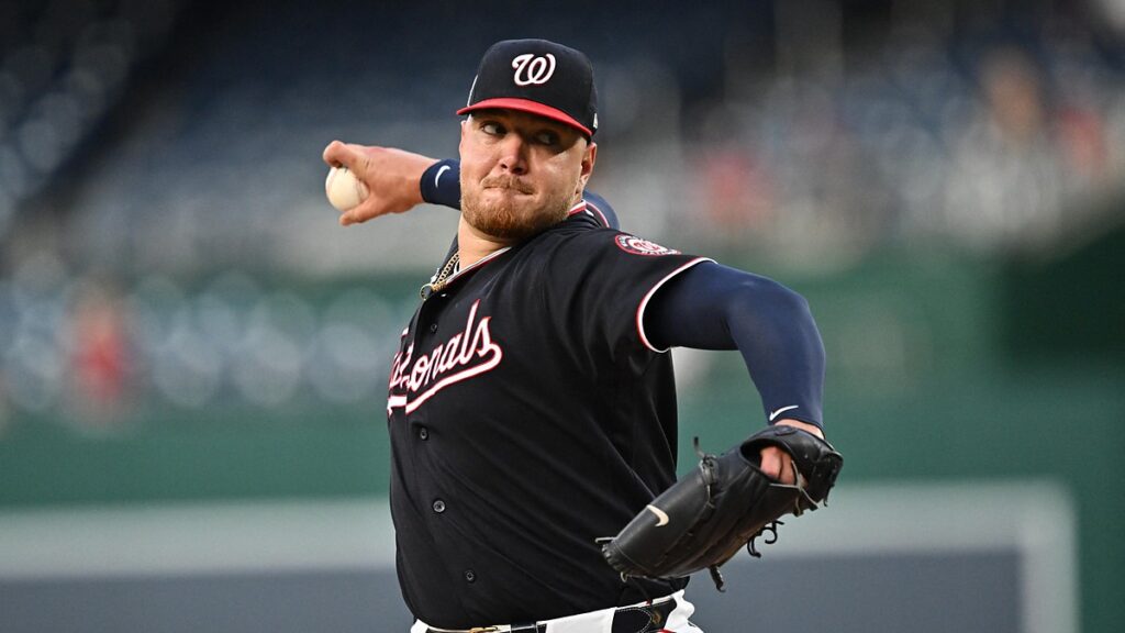 Washington Nationals pitcher Cade Cavalli comes through his delivery with the ball in his right hand.
