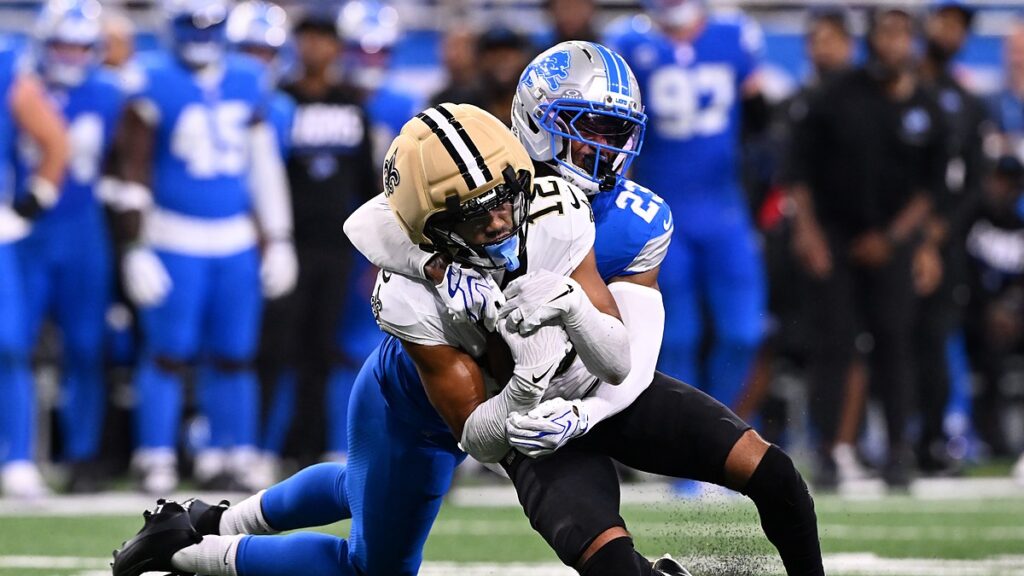 New Orleans Saints wide receiver Chris Olave is wrapped up from behind by Detroit Lions cornerback Rock Ya-Sin.