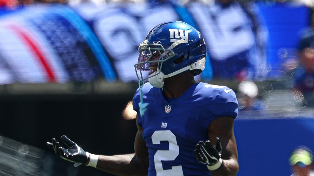 New York Giants cornerback Deonte Banks spreads his arms and gestures with both hands during a game.