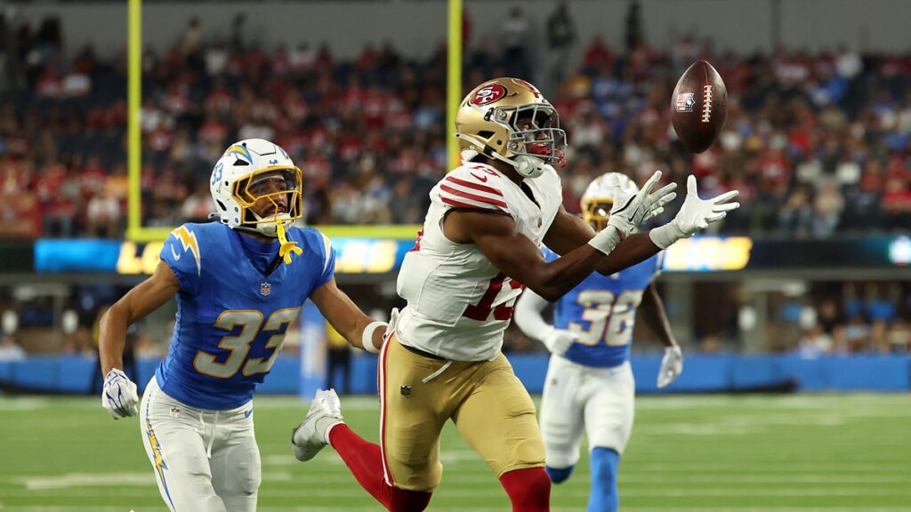 San Francisco 49ers wide receiver De’Zhaun Stribling reaches for a pass with Los Angeles Chargers cornerback Deane Leonard trailing.