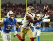 San Francisco 49ers wide receiver De’Zhaun Stribling reaches for a pass with Los Angeles Chargers cornerback Deane Leonard trailing.