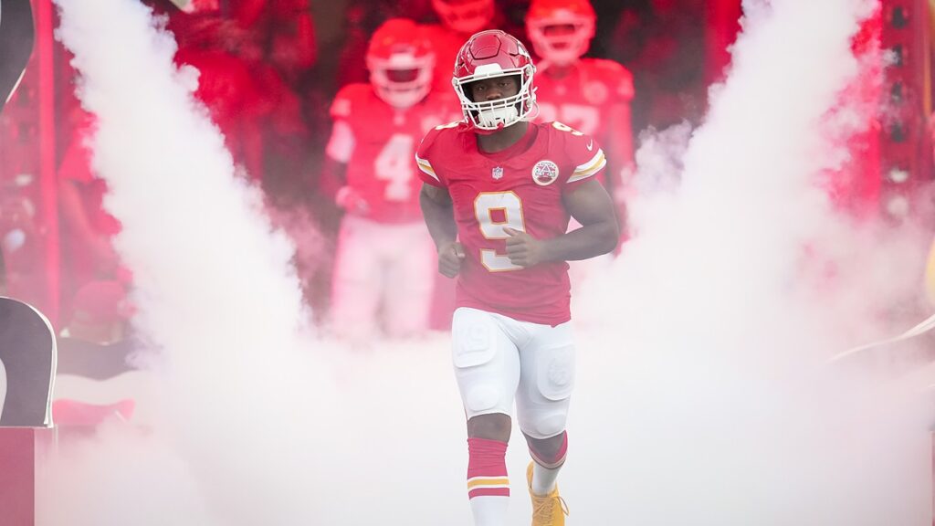 Kansas City Chiefs running back Kenneth Walker III jogs out of the tunnel through pregame smoke.