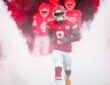 Kansas City Chiefs running back Kenneth Walker III jogs out of the tunnel through pregame smoke.