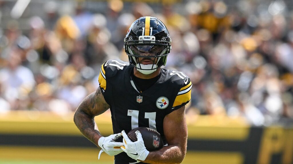 Pittsburgh Steelers wide receiver Michael Pittman Jr. runs upfield with the ball held in both hands.