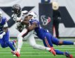 Houston Texans wide receiver Nico Collins holds the ball as Buffalo Bills cornerback Kani Walker wraps him up.