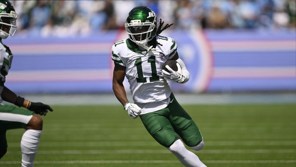 New York Jets wide receiver Omar Cooper Jr. cuts upfield with the ball tucked in his left arm.