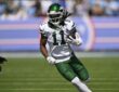New York Jets wide receiver Omar Cooper Jr. cuts upfield with the ball tucked in his left arm.