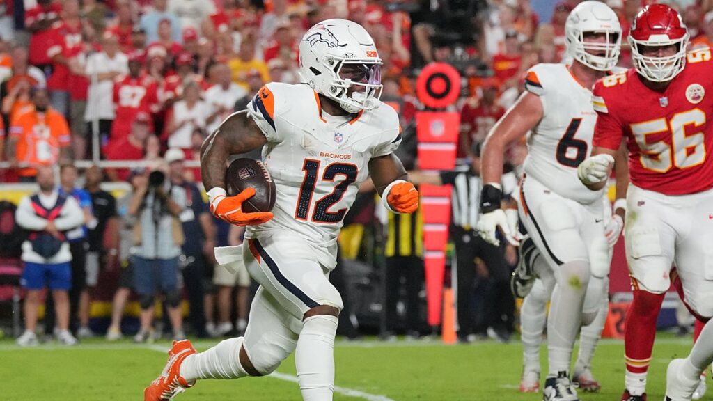 Denver Broncos running back RJ Harvey carries the ball in his right arm as he runs upfield against the Kansas City Chiefs.