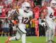 Denver Broncos running back RJ Harvey carries the ball in his right arm as he runs upfield against the Kansas City Chiefs.